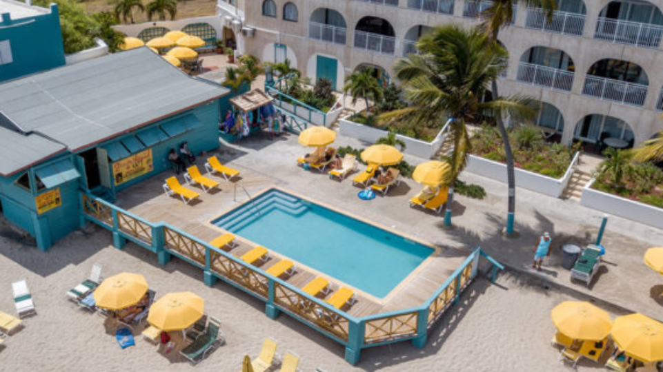 Resort pool at Belair Beach Hotel with beach chairs