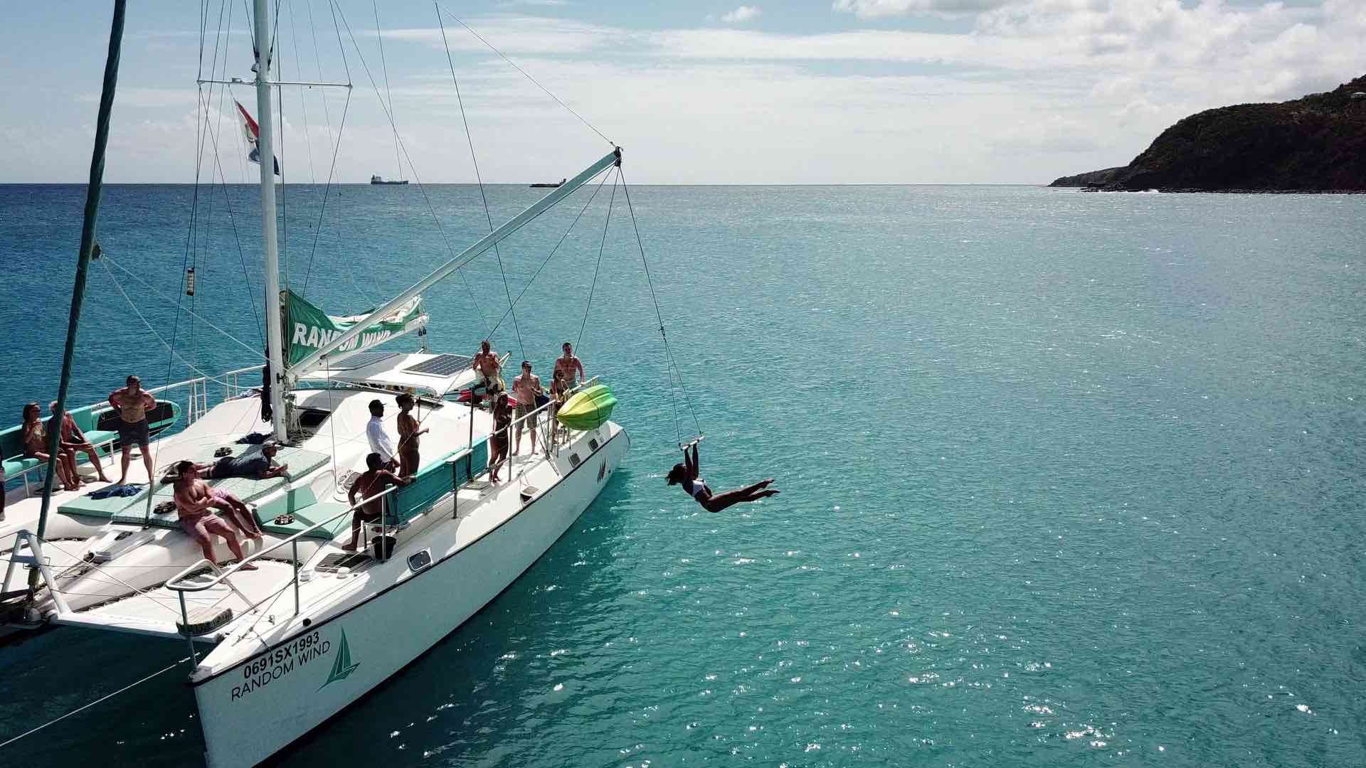 Random Wind Charters offer fun things to do in St Martin like sailing and jumping into the water off the boat using a swing