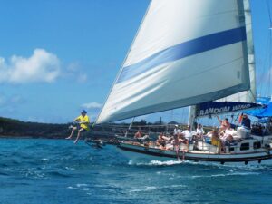 People aboard Random Wind Charters yacht under full sail